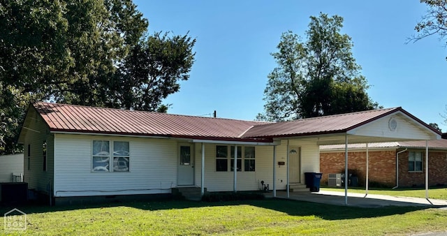 411 S Greenville St, Rector, AR 72461 - single story home with central air condition unit, entry steps, a carport, metal roof, and a front lawn