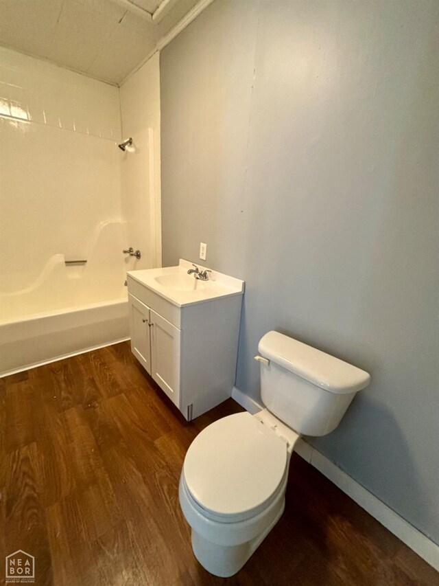 411 S Greenville St, Rector, AR 72461 - full bath with toilet, vanity, wood finished floors, and shower / bathtub combination
