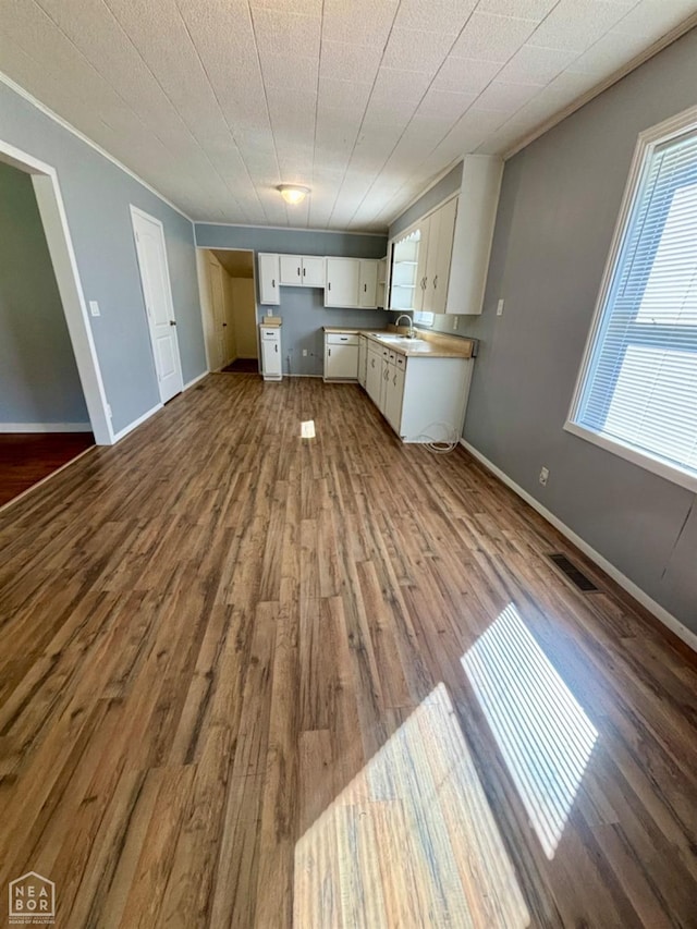 411 S Greenville St, Rector, AR 72461 - kitchen with white cabinets, visible vents, dark wood-style flooring, a sink, and baseboards