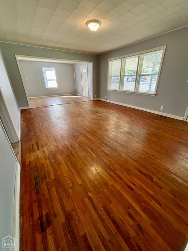 411 S Greenville St, Rector, AR 72461 - empty room with visible vents, baseboards, and hardwood / wood-style floors