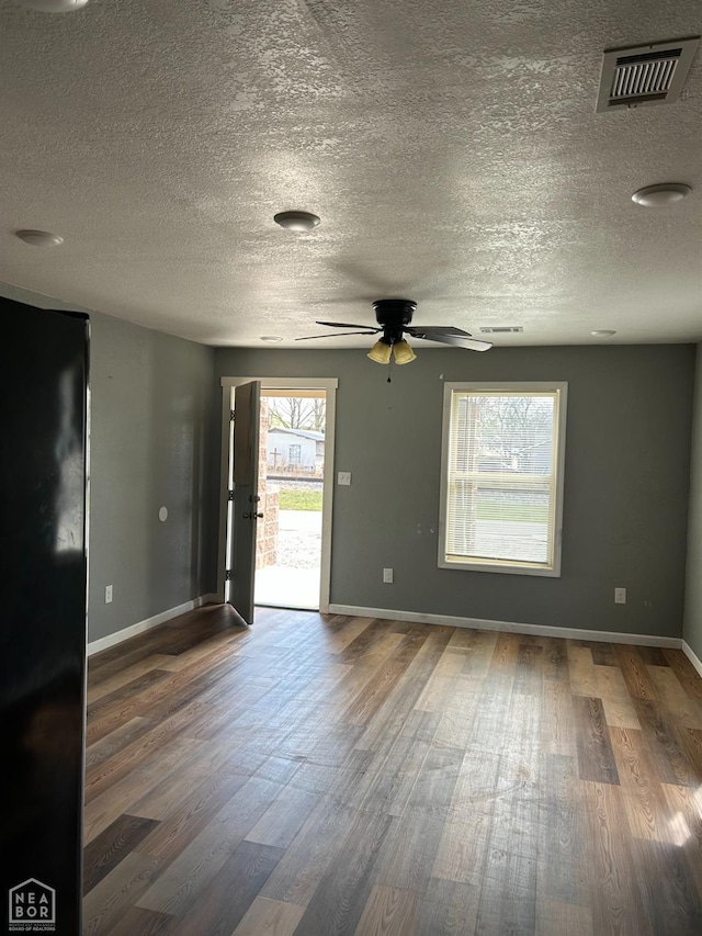 2209 Central St, Jonesboro, AR 72401 - spare room with visible vents, ceiling fan, baseboards, and wood finished floors
