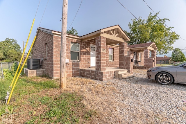2209 Central St, Jonesboro, AR 72401 - view of front of home with brick siding, fence, and central AC unit