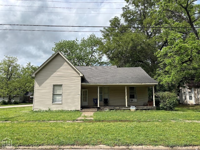 view of front facade with covered porch and a front yard