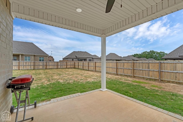 view of patio / terrace with grilling area, a fenced backyard, a ceiling fan, and a residential view