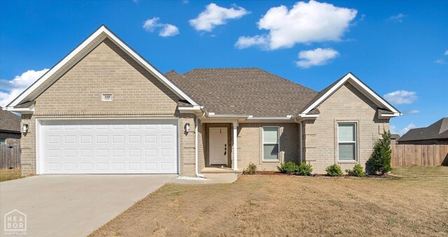 ranch-style house with concrete driveway, a front lawn, fence, a garage, and brick siding