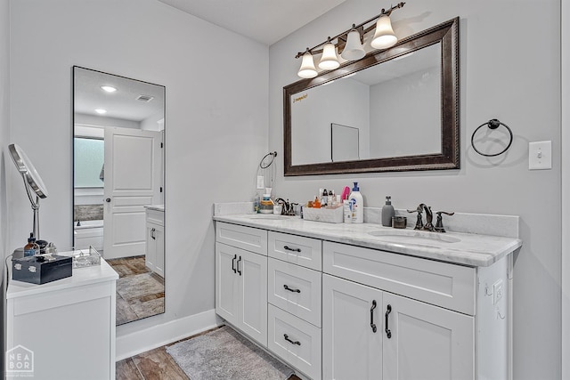4317 Cypress Pointe Ln, Jonesboro, AR 72405 - bathroom with double vanity and wood finished floors