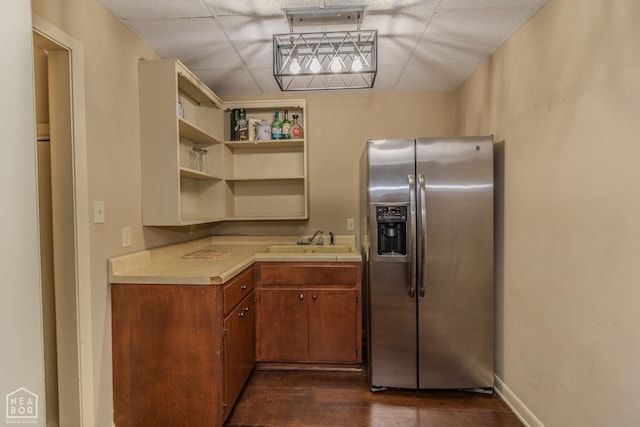 106 Winston Pl, Paragould, AR 72450 - kitchen featuring stainless steel fridge with ice dispenser, a sink, light countertops, a drop ceiling, and dark wood-style flooring