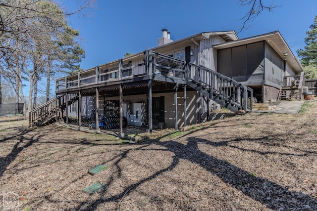 106 Winston Pl, Paragould, AR 72450 - rear view of property with stairs, a deck, a trampoline, and a chimney