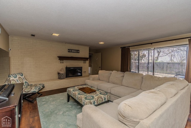 106 Winston Pl, Paragould, AR 72450 - living area with a fireplace, wood finished floors, and brick wall