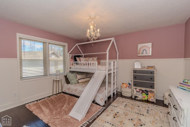 106 Winston Pl, Paragould, AR 72450 - bedroom featuring a chandelier, a wainscoted wall, and wood finished floors