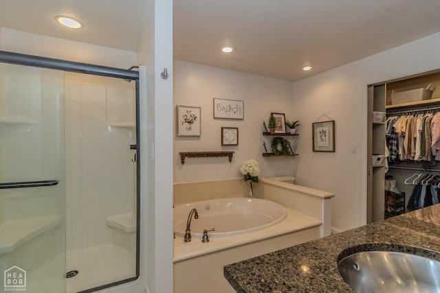 106 Winston Pl, Paragould, AR 72450 - full bath featuring a stall shower, a garden tub, vanity, a spacious closet, and recessed lighting