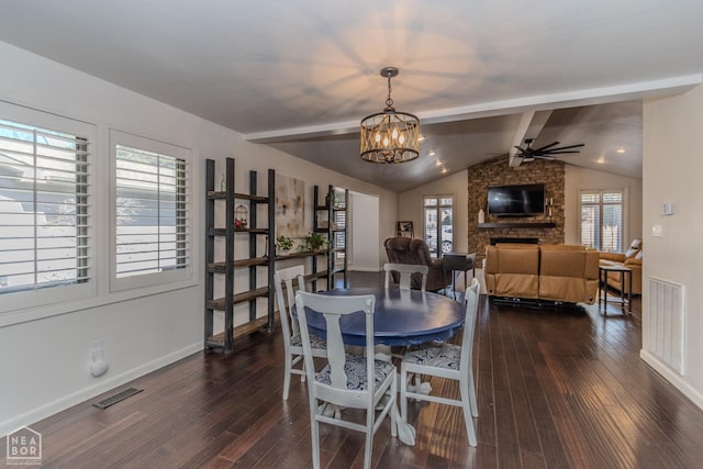 106 Winston Pl, Paragould, AR 72450 - dining area featuring dark wood finished floors, a chandelier, a fireplace, ceiling fan, and baseboards