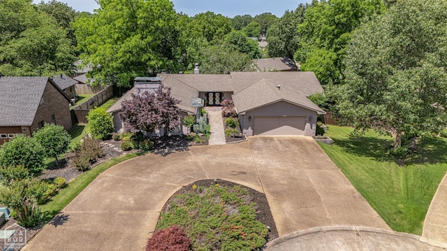106 Winston Pl, Paragould, AR 72450 - view of front of home with driveway, a garage, a front lawn, french doors, and roof with shingles