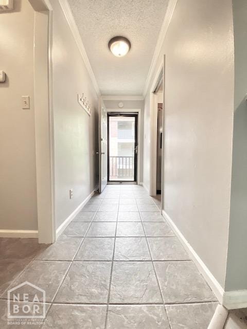 1300 S Church St, Jonesboro, AR 72401 - hallway featuring crown molding, light tile patterned floors, baseboards, and a textured ceiling
