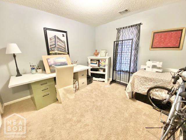 1300 S Church St, Jonesboro, AR 72401 - bedroom featuring visible vents, a textured ceiling, and light colored carpet