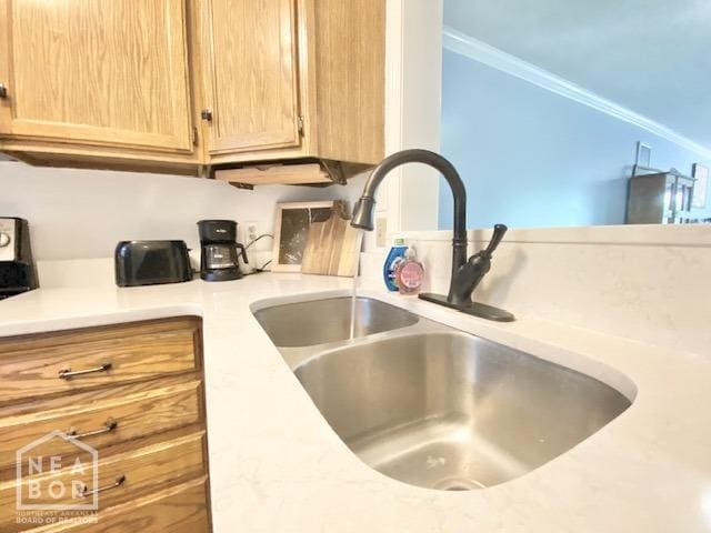 1300 S Church St, Jonesboro, AR 72401 - details featuring light countertops, a sink, light brown cabinets, and ornamental molding