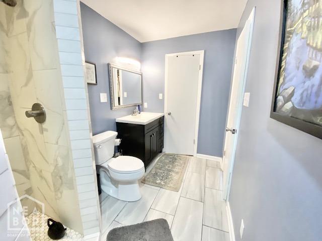 1300 S Church St, Jonesboro, AR 72401 - full bathroom featuring toilet, a marble finish shower, and vanity