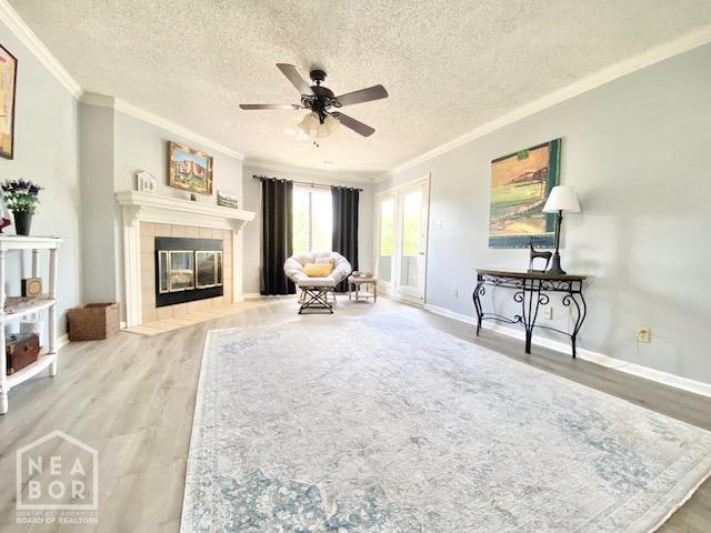 1300 S Church St, Jonesboro, AR 72401 - living area featuring crown molding, a ceiling fan, a textured ceiling, and wood finished floors