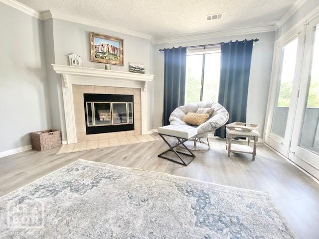 1300 S Church St, Jonesboro, AR 72401 - living area with a textured ceiling, visible vents, ornamental molding, and wood finished floors