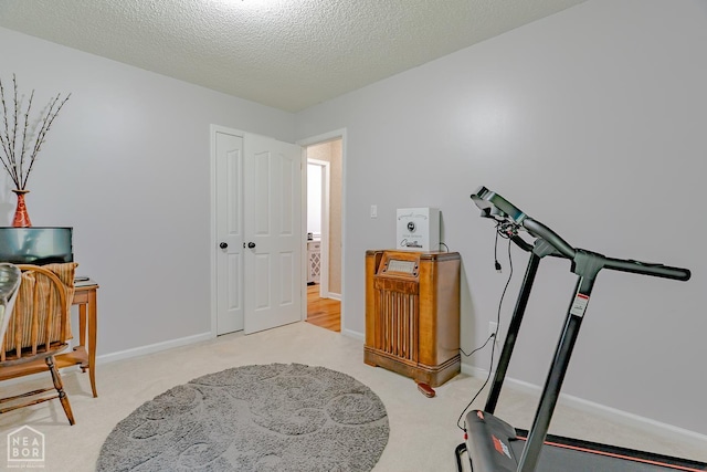 1207 Hunters Run Cv, Jonesboro, AR 72401 - exercise room featuring carpet floors, baseboards, and a textured ceiling