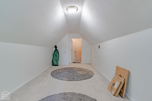 1207 Hunters Run Cv, Jonesboro, AR 72401 - additional living space featuring a textured ceiling, vaulted ceiling, baseboards, and carpet floors