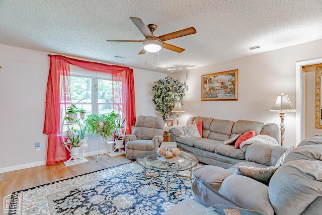 1207 Hunters Run Cv, Jonesboro, AR 72401 - living area featuring ceiling fan, wood finished floors, a textured ceiling, and baseboards