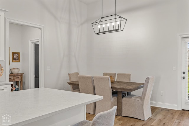 107 Hidden Creek St, Brookland, AR 72417 - dining area featuring light wood finished floors, a chandelier, and baseboards