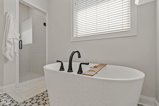 107 Hidden Creek St, Brookland, AR 72417 - full bath featuring a stall shower, a freestanding bath, baseboards, and tile patterned floors