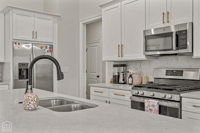 107 Hidden Creek St, Brookland, AR 72417 - kitchen with stainless steel appliances, a sink, backsplash, and white cabinets