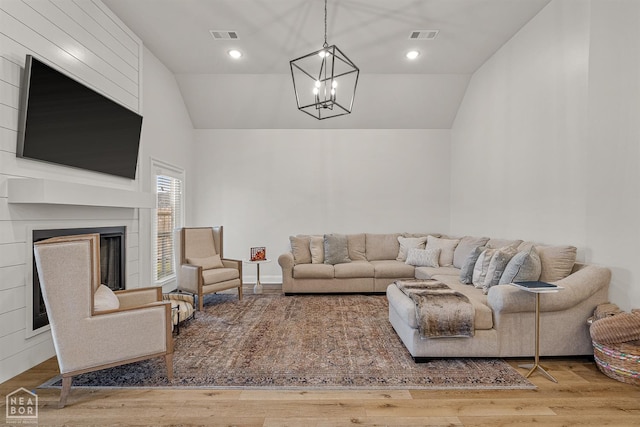 107 Hidden Creek St, Brookland, AR 72417 - living room with lofted ceiling, a chandelier, a fireplace, and wood finished floors