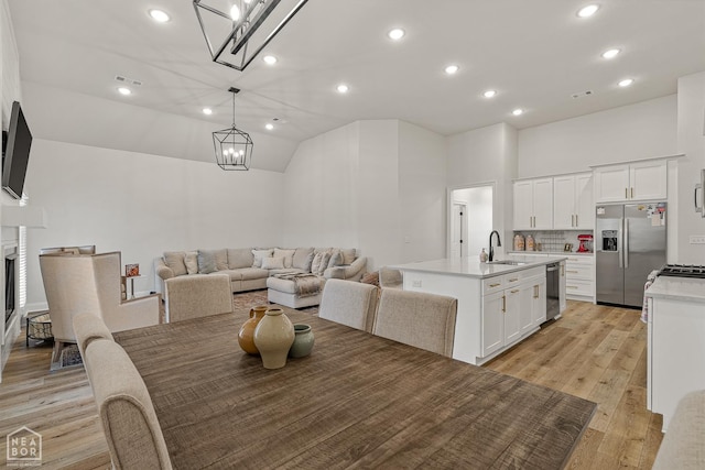 107 Hidden Creek St, Brookland, AR 72417 - dining area featuring a chandelier, light wood-style flooring, recessed lighting, a fireplace, and lofted ceiling