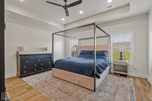 107 Hidden Creek St, Brookland, AR 72417 - bedroom featuring baseboards, wood finished floors, recessed lighting, a ceiling fan, and a tray ceiling