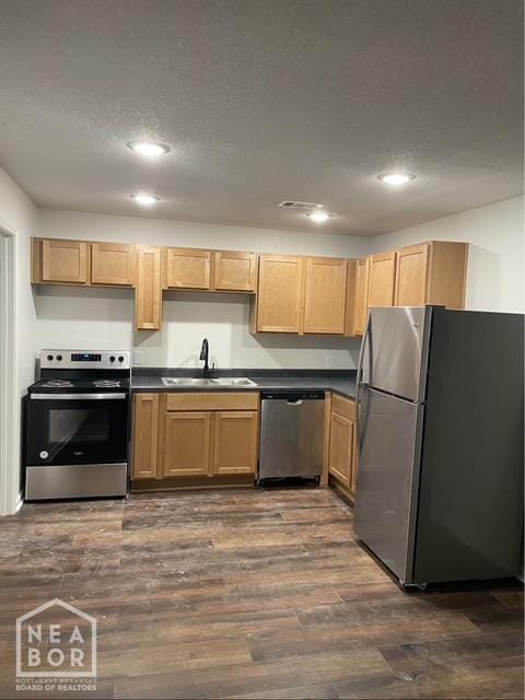 1500 W Nettleton Ave, Jonesboro, AR 72401 - kitchen with appliances with stainless steel finishes, a sink, recessed lighting, dark countertops, and dark wood-style floors