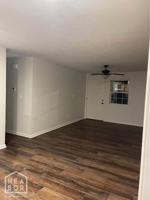 1500 W Nettleton Ave, Jonesboro, AR 72401 - empty room featuring dark wood-style floors, a ceiling fan, and baseboards
