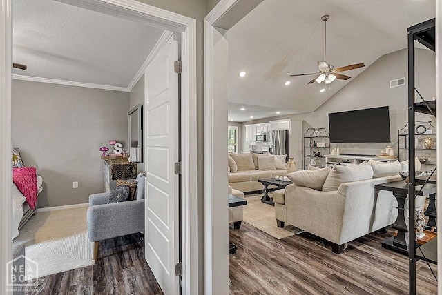 2100 N 29th St, Paragould, AR 72450 - living area featuring ceiling fan, visible vents, dark wood-style floors, lofted ceiling, and ornamental molding