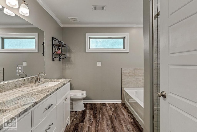 2100 N 29th St, Paragould, AR 72450 - bathroom featuring toilet, visible vents, wood finished floors, and vanity