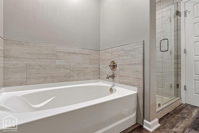 2100 N 29th St, Paragould, AR 72450 - full bath featuring a garden tub, wood finished floors, and a shower stall