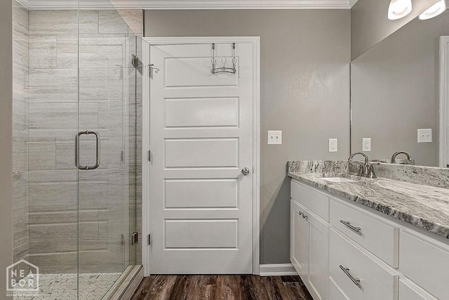 2100 N 29th St, Paragould, AR 72450 - full bathroom featuring wood finished floors, a shower stall, ornamental molding, and vanity