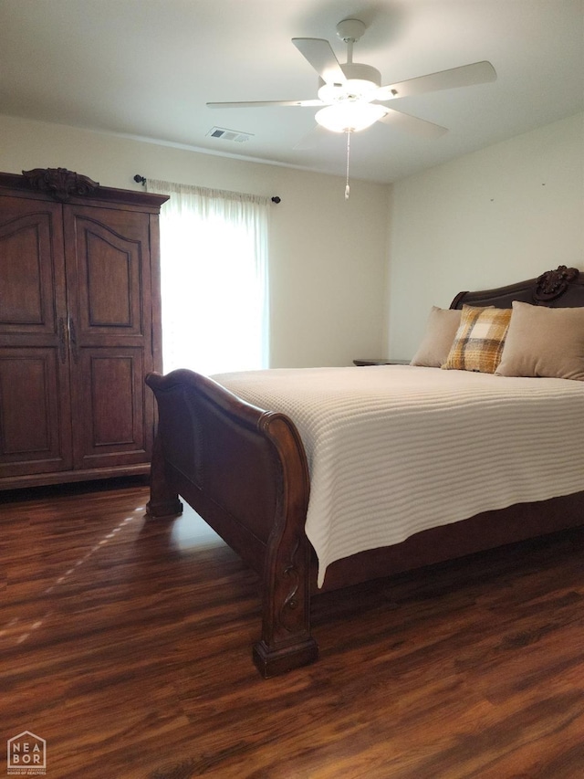 bedroom featuring visible vents, ceiling fan, and dark wood-style floors