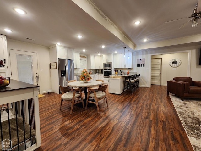 dining room with recessed lighting, visible vents, crown molding, and dark wood finished floors
