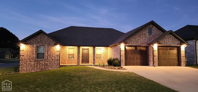 view of front of home with a front yard, an attached garage, brick siding, and driveway