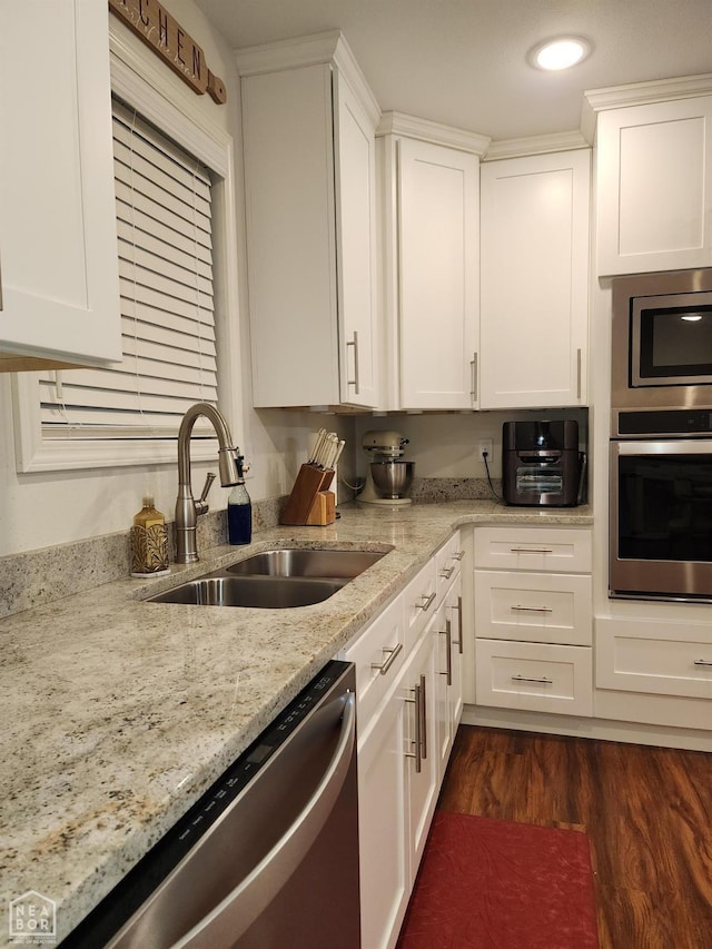 kitchen featuring a sink, white cabinets, dark wood-style floors, and stainless steel appliances