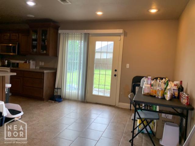 4709 Summit Ridge Dr, Jonesboro, AR 72404 - dining room featuring plenty of natural light, recessed lighting, light tile patterned flooring, and baseboards