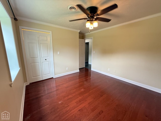 1354 Wiley Dr, Piggott, AR 72454 - unfurnished bedroom featuring dark wood-style floors, ornamental molding, and ceiling fan