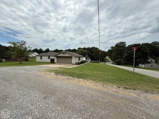 1354 Wiley Dr, Piggott, AR 72454 - view of front of house featuring driveway and a front lawn