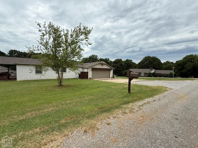 1354 Wiley Dr, Piggott, AR 72454 - ranch-style house with driveway, a front lawn, and a garage