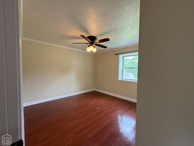 1354 Wiley Dr, Piggott, AR 72454 - spare room with dark wood-style floors, ornamental molding, ceiling fan, and a textured ceiling