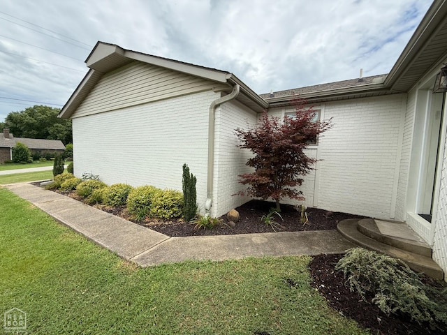 1354 Wiley Dr, Piggott, AR 72454 - view of property exterior with brick siding and a lawn