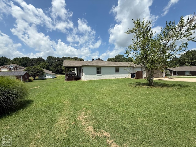 1354 Wiley Dr, Piggott, AR 72454 - back of house with a lawn, concrete driveway, and an attached garage