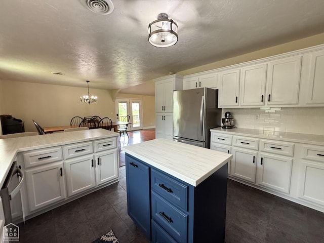 1354 Wiley Dr, Piggott, AR 72454 - kitchen featuring stainless steel appliances, blue cabinets, white cabinetry, and light countertops